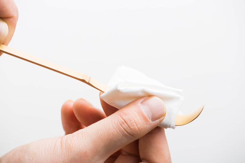 Cleaning off Ippodo chashaku bamboo tea ladel by wiping with white fukin Japanese ceremonial cloth