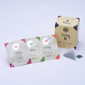 Ippodo Tea box with three packaged tea bags labeled Gyokuro, Sencha, and Hojicha, and one mesh tea bag beside them. - thumbnail 3