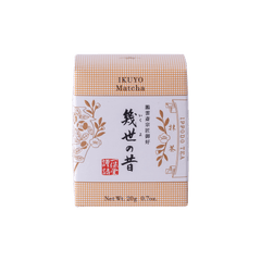 Unopened box of Ippodo Tea Co. Ikuyo matcha powder with peach color hashmarks, Japanese characters and gold flowers leaves