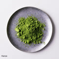 Loose green finely ground premium verdant green Japanese Ippodo Kanza Matcha tea powder on silver plate on white table