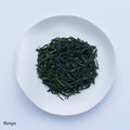 White plate of dark green loose leaf Ippodo Tea Rimpo gyokuro tea leaves on white table