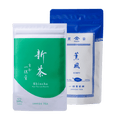 Bright green and white pouch of Uji Shincha tea with white Japanese writing beside blue package of Kumpu premium sencha tea