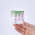Hand holding limited edition Nodoka matcha box 20g from Ippodo Tea green pink gradient floral design Japanese tea powder Kyoto spring