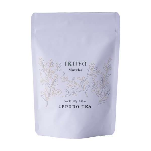 White 100 gram bag of Ippodo Tea Ikuyo matcha powder for with line drawing of gold and green leaves of the tea plant