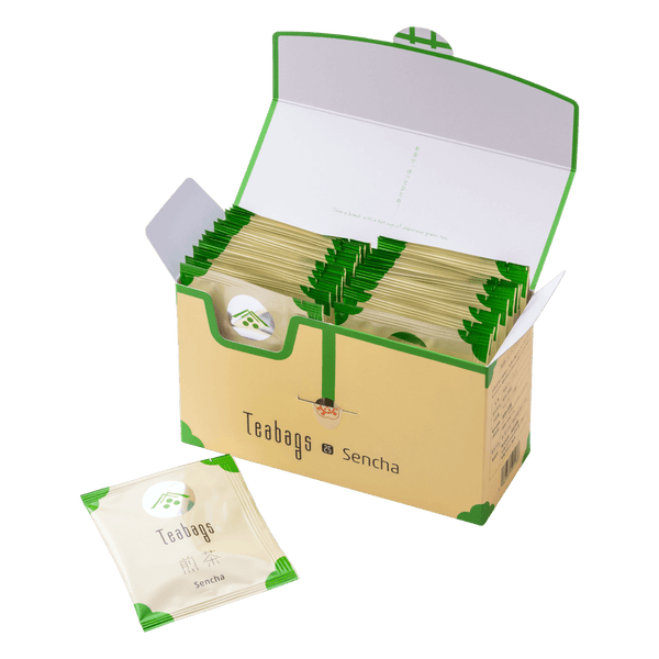 Open cream box containing 25 individually wrapped Sencha Teabags beside one teabag packet with green corners and Ippodo logo