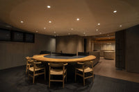 Front of of Ippodo Tea's flagship store, tearoom and headquarters black storefront in Kyoto, Japan with outdoor lit neon sign