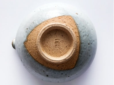 Ippodo Tea - White Tea Bowl with Spout - Contrasting earthenware pokes out at the foot of the bowl.